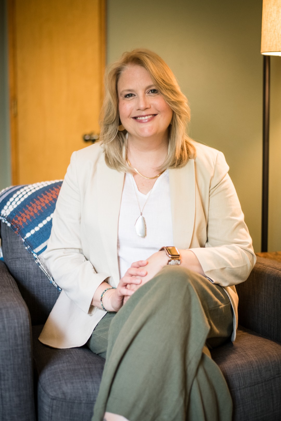 Smiling woman sitting on a chair indoors