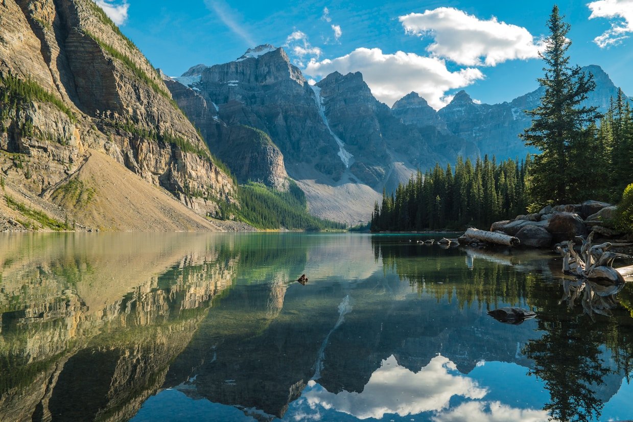 Majestic mountains reflect in a serene lake.
