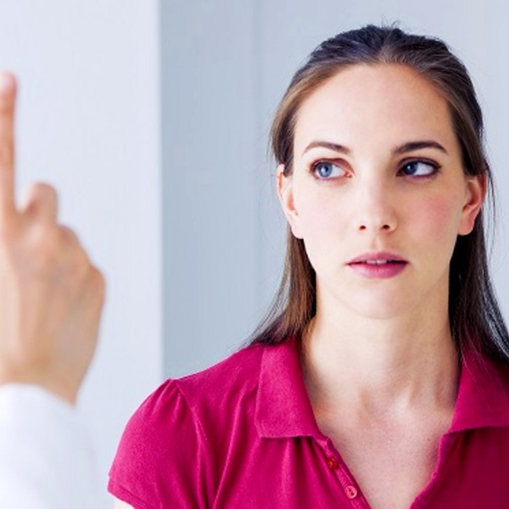 Woman takes eye movement test with doctor