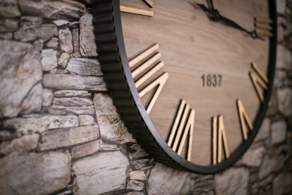 Wooden wall clock with Roman numerals
